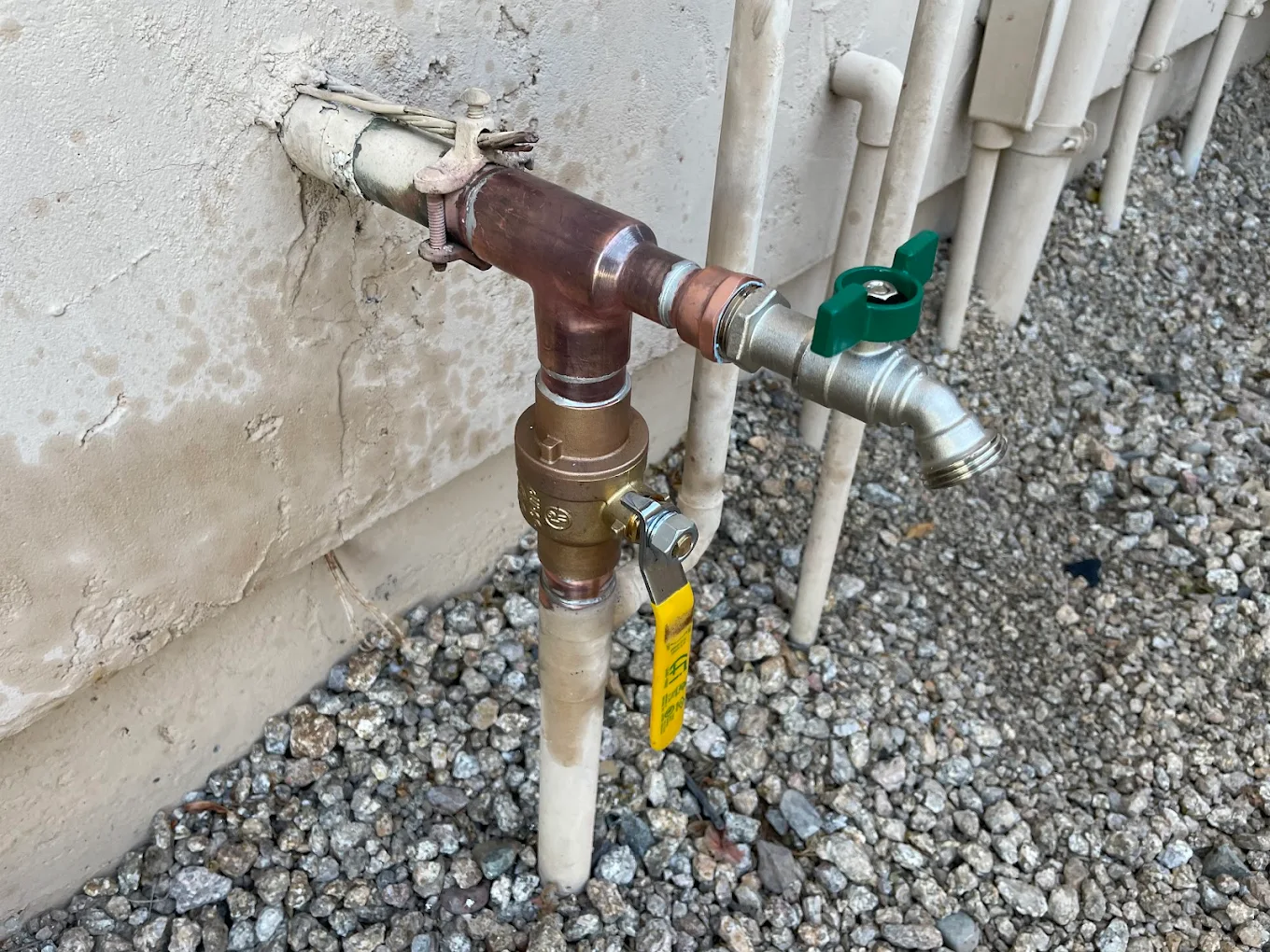 Exterior copper hose bibb with shut-off valve and backflow preventer installation